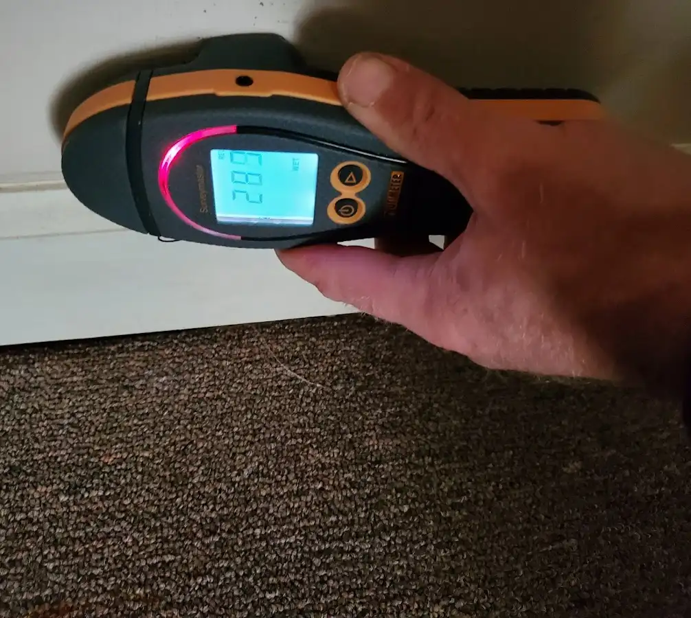 Moisture detection at baseboard during Storm Damage Restoration in Glen Cove